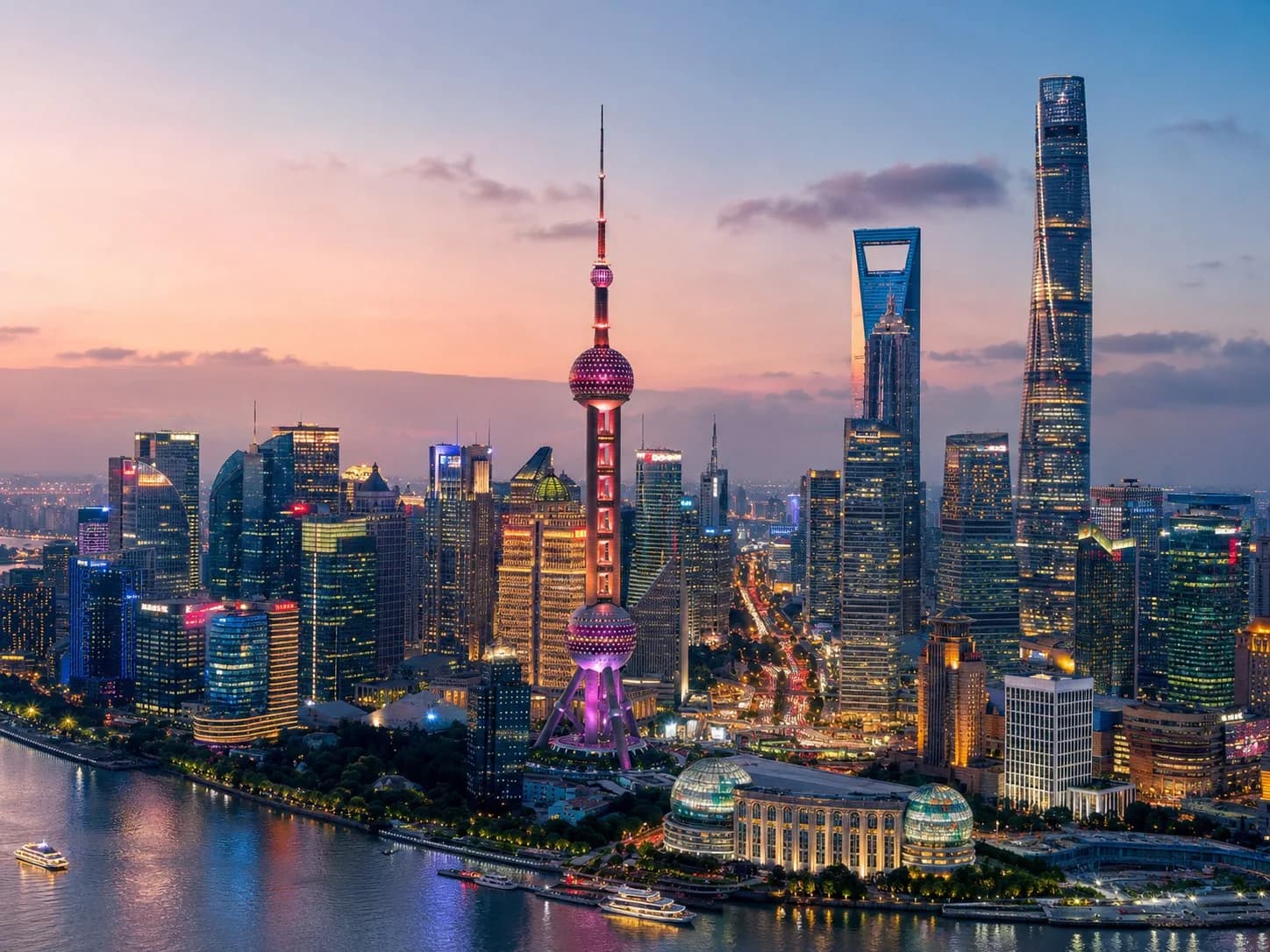 Shanghai Pudong skyline at dusk, with the Oriental Pearl Tower and Huangpu River