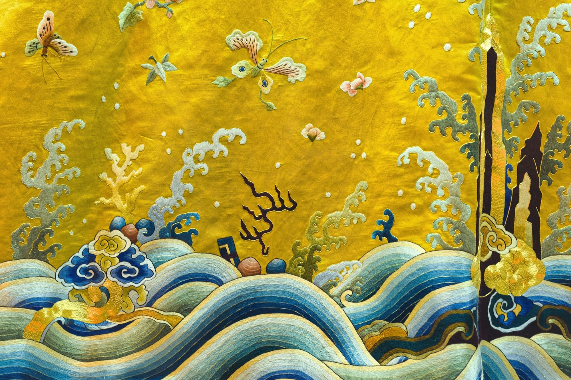 Silk embroidery of waves, clouds and butterflies on a yellow ground
