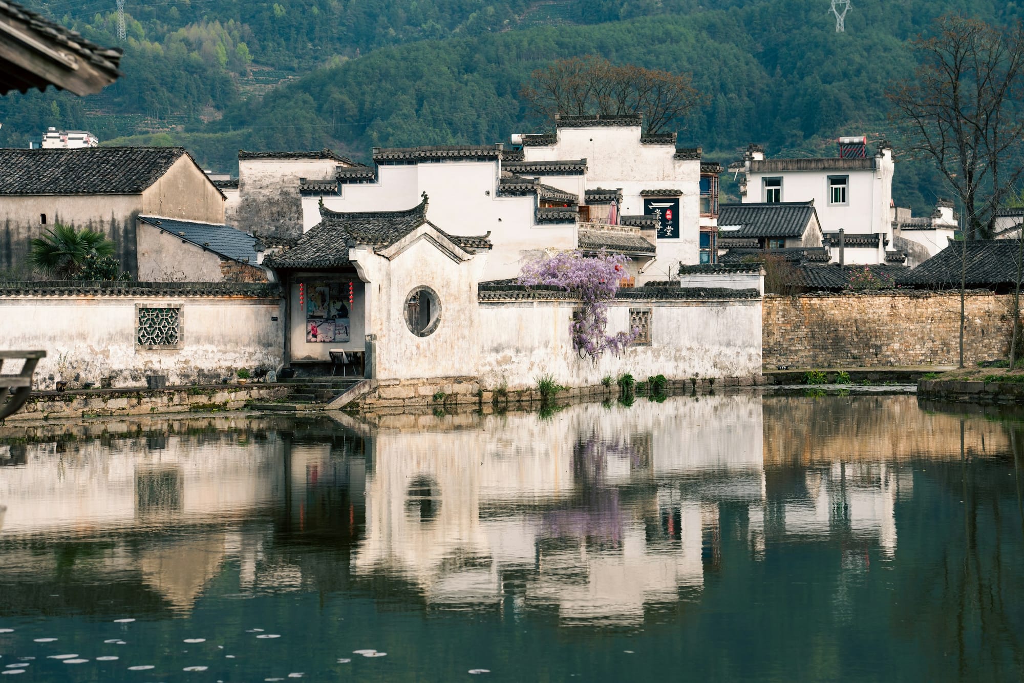 Un pueblo Huizhou de muros blancos reflejado en un estanque cerca de Huangshan, Anhui